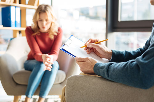 anxiety counseling A woman talks to her counselor during a social anxiety counseling session