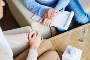 A woman talks to a counselor about Houston behavioral health services
